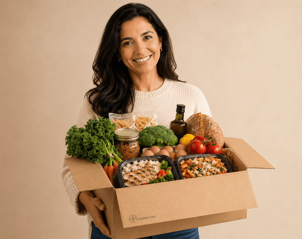 Smiling woman carrying delivery box full of fresh groceries